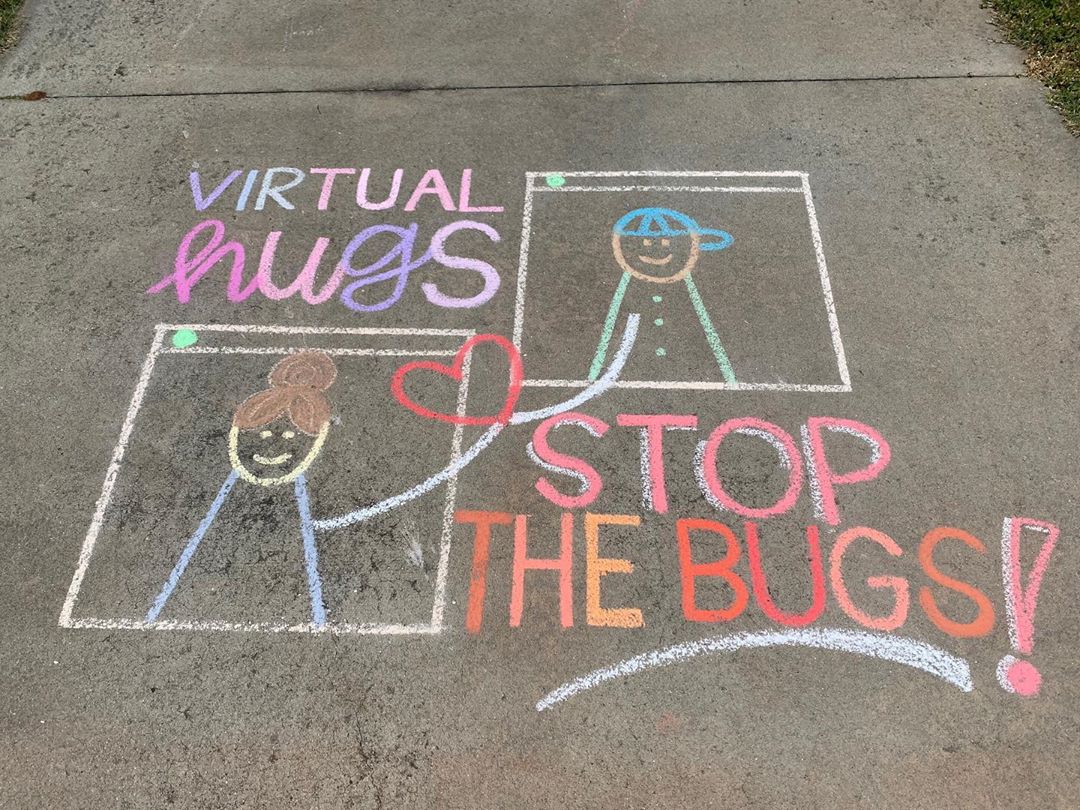 An uplifting and hopeful chalk drawing on the sidewalk.