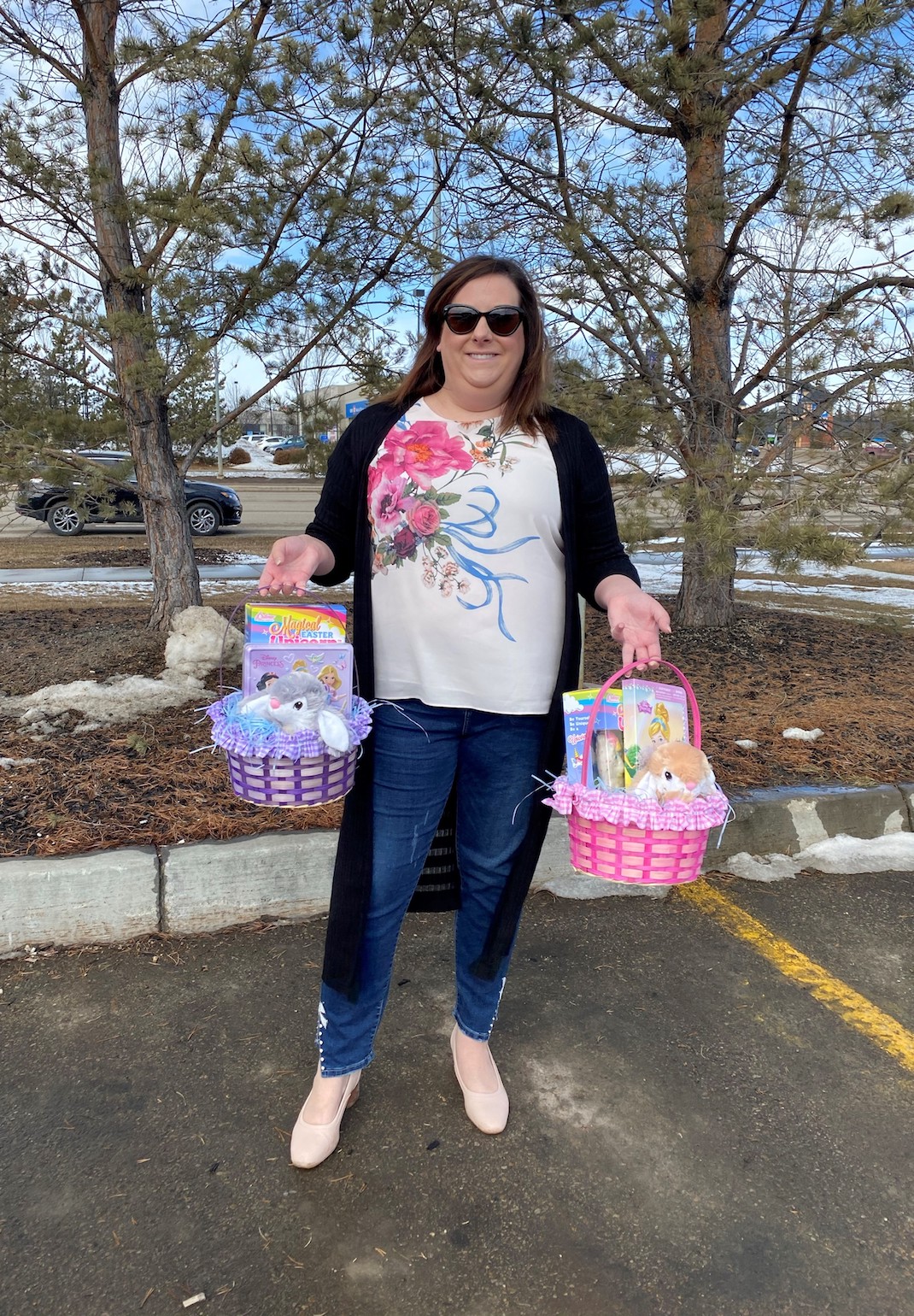 A woman holding donated Easter baskets.