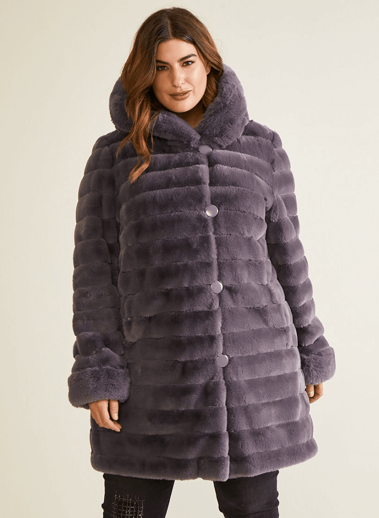Model wearing faux fur coat.